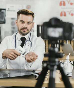 Doctor recording vlog with contactless thermometer in hands